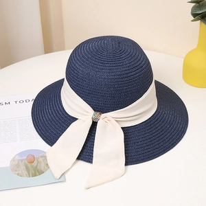 Navy blue woven straw sun hat with creamy ribbon and elegant rhinestone bow decoration