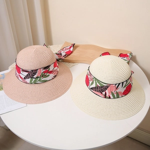 Women's wide brim straw sun hats with floral ribbon bow in cream and pink tones