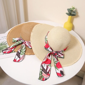 Summer wide-brim straw sun hats for women with floral ribbon and frayed edges in beach style
