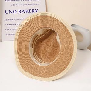 Detail view of woven straw sun hat interior with soft sweatband and contrast brim trim