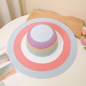 Close-up of a wide brim straw hat featuring colorful pastel striped weaving for summer