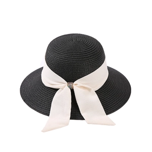 Elegant black straw sun hat for women featuring a wide brim and creamy ribbon bow with rhinestones