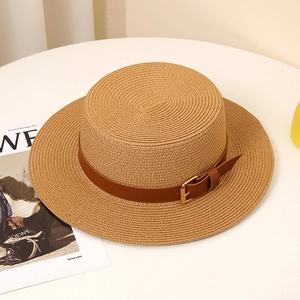 Detail of boater hat texture with brown leather strap and golden metal buckle