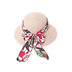 Women's straw sun hat with tropical floral ribbon bow and wide flat brim on white background