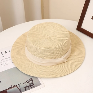 Detail of light beige boater hat showing fine straw weave texture and matching ribbon