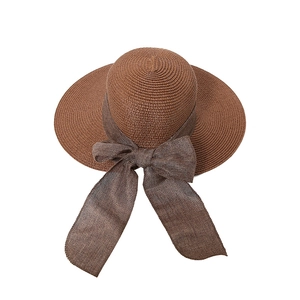 Women's wide brim straw sun hat with elegant bow ribbon in brown woven texture