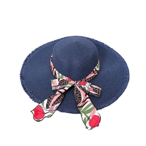 Dark blue wide brim straw hat with floral ribbon bow for summer sun protection beach vacation