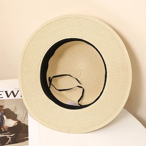 Detail of woven straw sun hat showing interior sweatband and adjustable drawstring