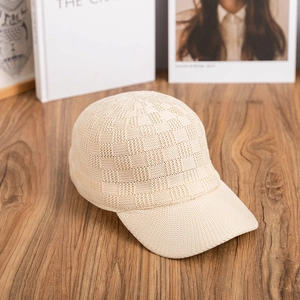 Close-up of the cream checkerboard knitted texture on this stylish baseball cap