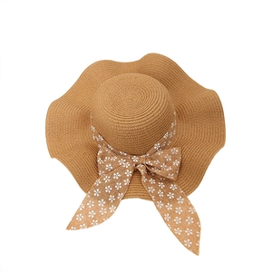 Summer lace straw sun hat for women with wavy brim and floral bow ribbon detail