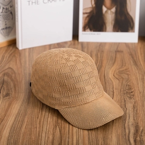 Khaki checkered knit baseball cap featuring breathable grid texture on wooden surface