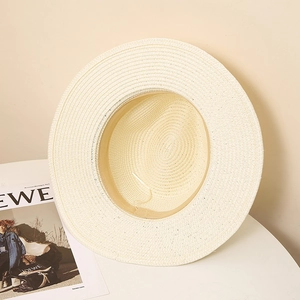 Detailed view of cream straw hat interior with adjustable drawstring and sweatband