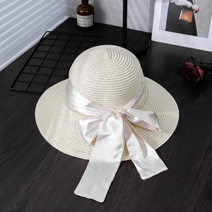 Elegant wide brim straw hat with pink silk bow and pearl chain for summer sun protection