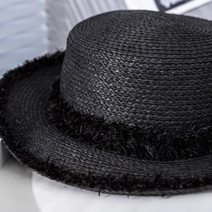 Chic black straw boater hat with frayed edge detailing and flat brim for sun protection