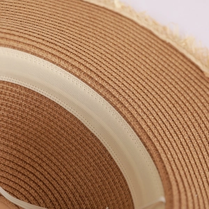 Detail of straw hat interior with sweatband and decorative fringe frayed edge
