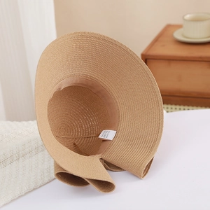 Detailed macro view of the inner sweatband and 100% paper material label of the sun hat