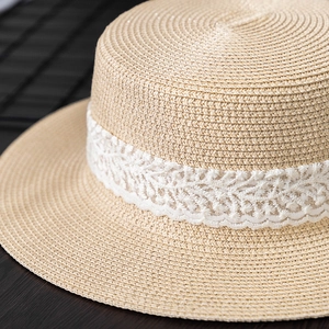 Close-up of summer boater hat showing intricate straw weaving and delicate lace trim detail