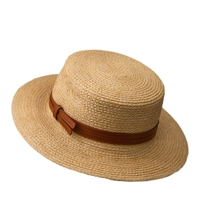 Flat top straw boater hat with wide brim and brown leather band for summer sun protection