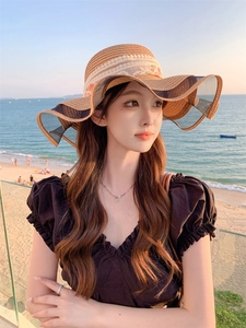 Detailed texture of straw sun hat with delicate lace ribbon and pink flower embroidery