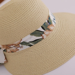 Detailed macro view of woven straw hat texture with elegant floral ribbon detail