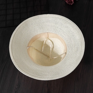 Detailed view of the internal weave, sweatband, and adjustable string of the straw sun hat