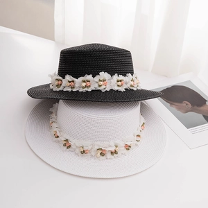 Detailed texture of straw boater hats with 3D floral band in black and white colors