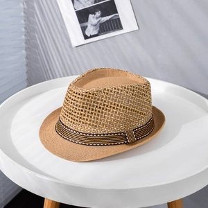 Detailed texture of breathable woven paper straw fedora hat with black and white striped band
