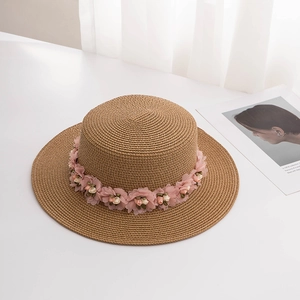 Women's summer straw hat with pink floral trim for beach vacation sun protection