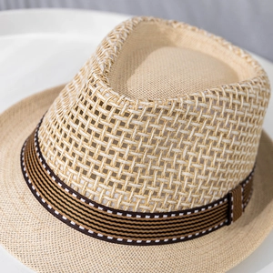 Detailed macro view of the breathable hollow grid weave and striped ribbon on the fedora hat