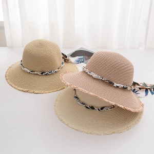 Straw sun hats with pearl beads and floral ribbons in beige, natural, and pink tones