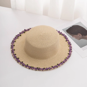 Beige wide brim straw sun hat with purple flower embroidery for beach vacations