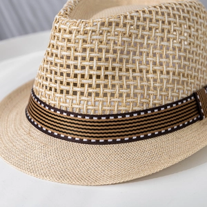 Close-up of breathable woven straw fedora hat featuring a striped decorative ribbon band