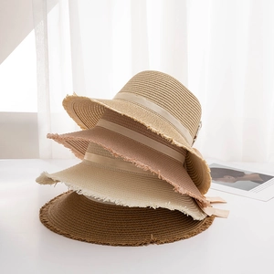 Women's straw sun hats with bow ribbons and frayed edges in multiple summer colors