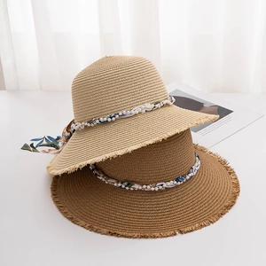 Women summer straw hats in beige and brown with pearl beads and floral ribbons