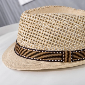 Detail of breathable hollow-weave paper straw hat with striped ribbon band