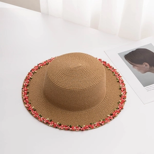 Women's straw sun hat with red floral trim for summer beach vacation and outdoor travel