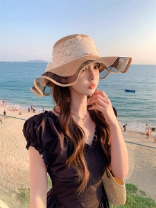 Detailed texture of woven straw sun hat with elegant pearl lace and wavy mesh brim