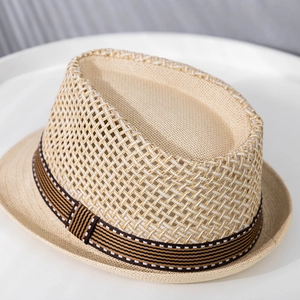 Detailed close-up of woven paper straw fedora hat with striped ribbon for summer sun protection