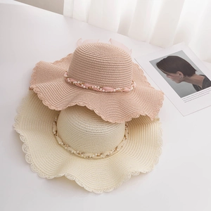 Wide brim straw sun hat with pearls and ribbons in pink and beige colors for women