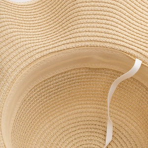Detail of hand-woven straw hat showing sweatband and elastic chin strap