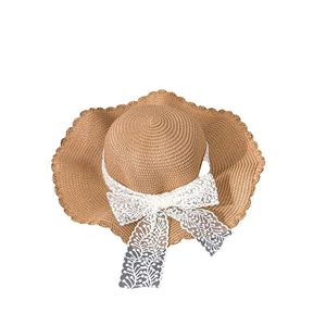 Women's summer straw sun hat with wide wavy brim and sweet white lace bow decoration