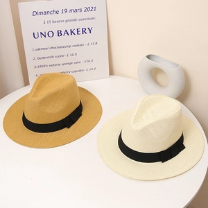 Classic wide-brim straw sun hats in yellow and ivory with black decorative ribbon bow