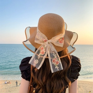 Women's summer straw sun hat with pink floral lace bow for beach vacation outfits