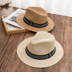 Close-up of fine textured weave and striped ribbon detail on summer straw fedora hats