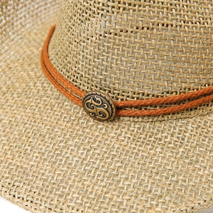 Detail of woven straw hat featuring orange decorative rope and antique bronze metal button
