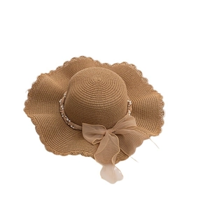 Brown wide brim straw sun hat with pearl strand and large elegant chiffon bow accent