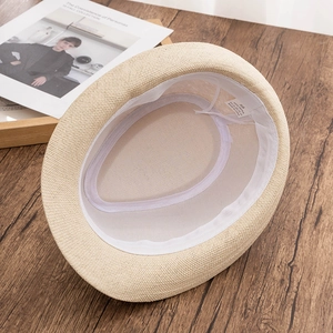 Internal view of beige straw fedora showing adjustable sweatband and 58cm size label