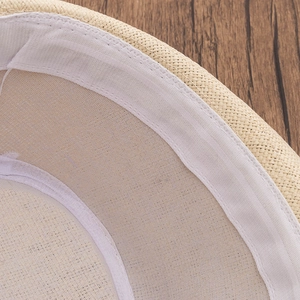 Detailed macro view of the interior woven straw texture and white inner sweatband of the hat