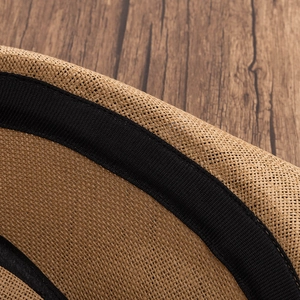 Close-up of natural woven straw hat texture with an elegant black grosgrain ribbon detail