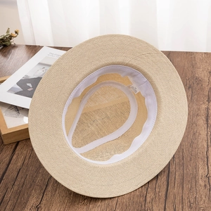 Detail view of woven sun hat interior showing size XL label and white sweatband inside